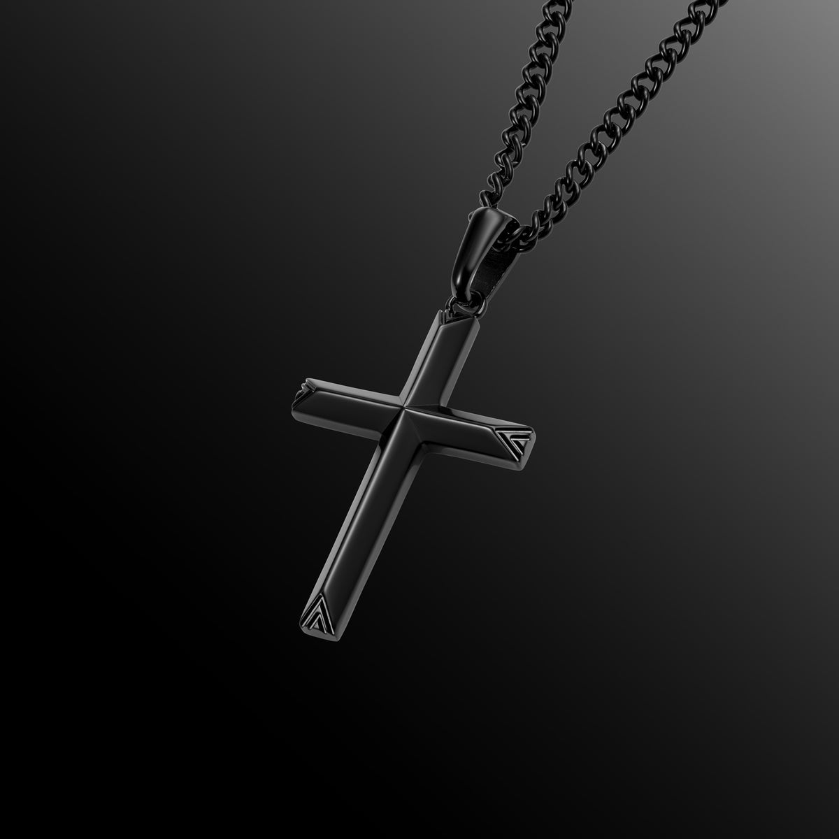 Black cross pendant on a chain against a dark background
