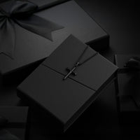 Black jewelry box with a necklace on a black background