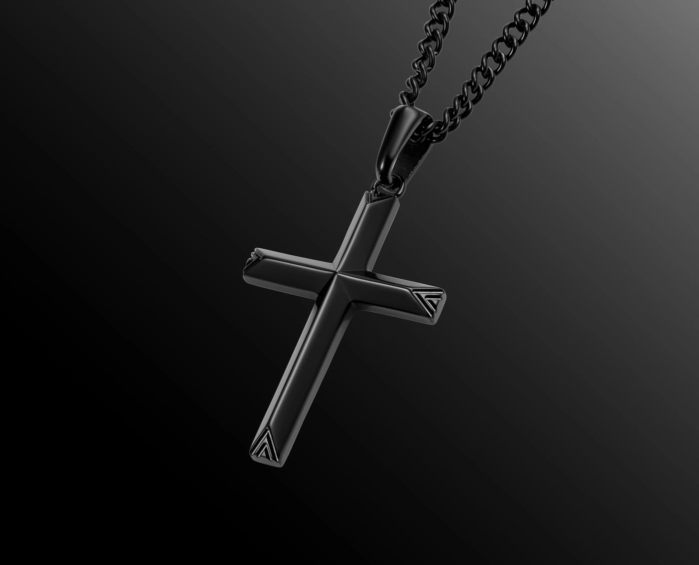 Black cross pendant on a chain against a dark background
