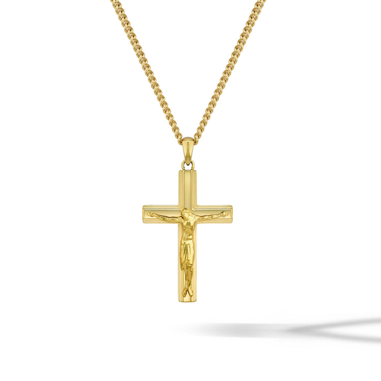 Gold crucifix pendant on a chain against a white background