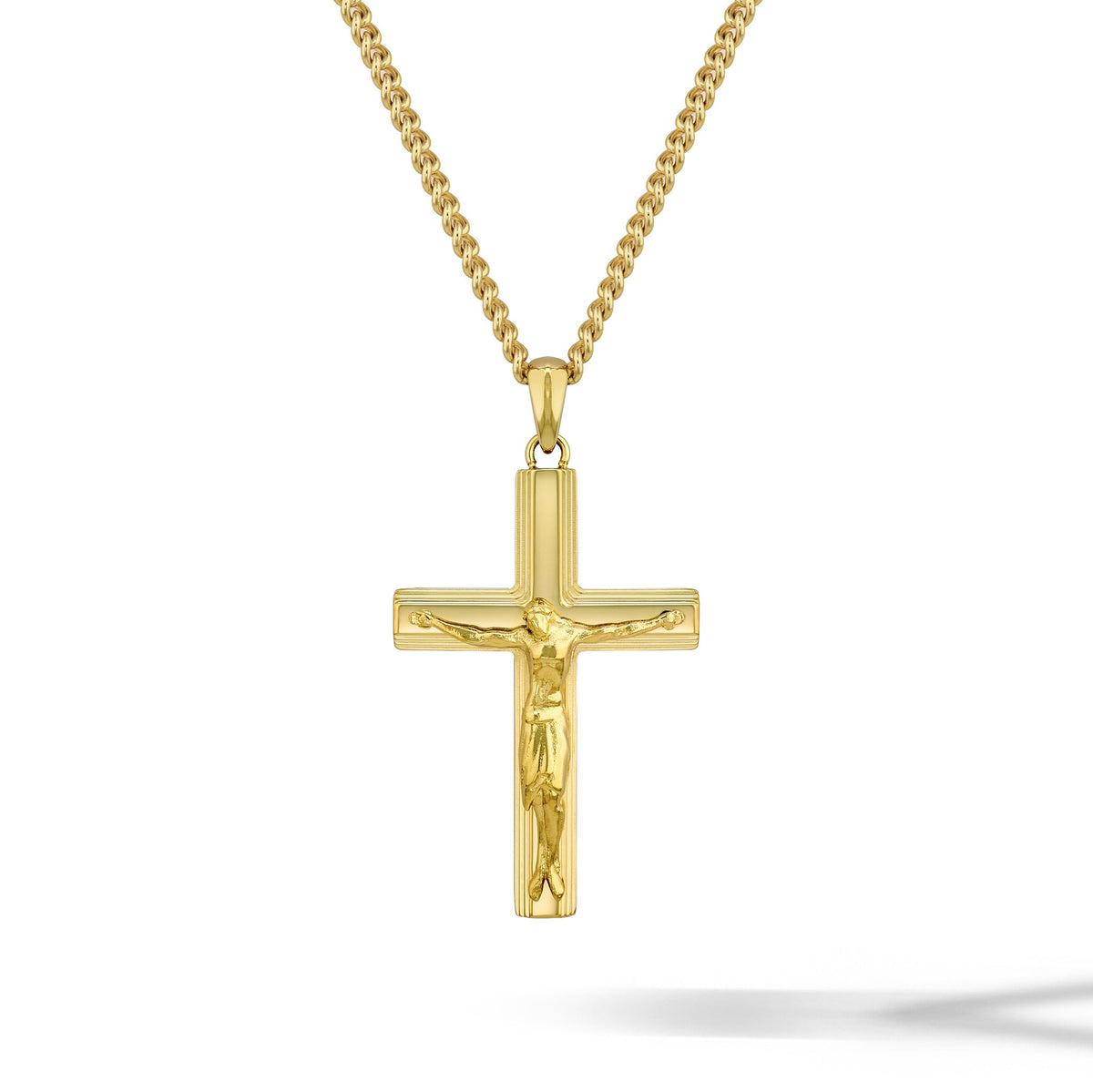 Gold crucifix pendant necklace on a white background