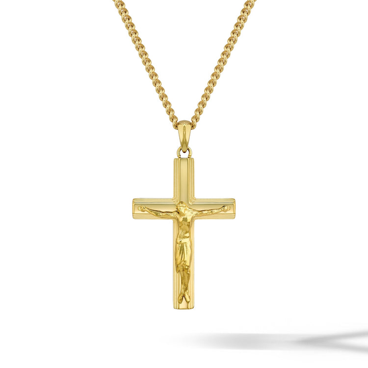 Gold crucifix pendant necklace on a white background