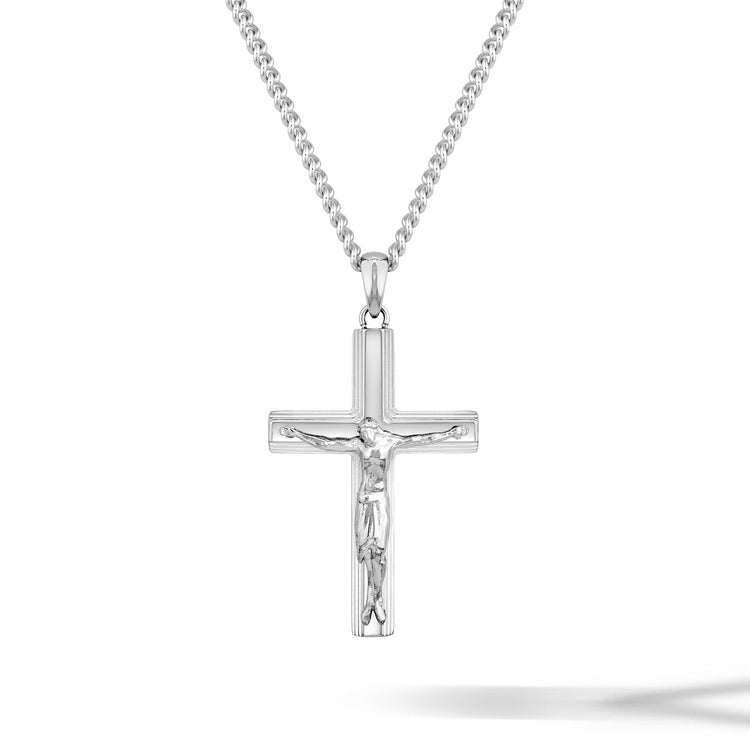 Silver crucifix pendant on a chain against a white background