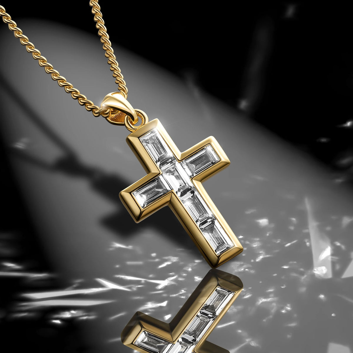 Gold cross pendant with clear stones on a reflective surface