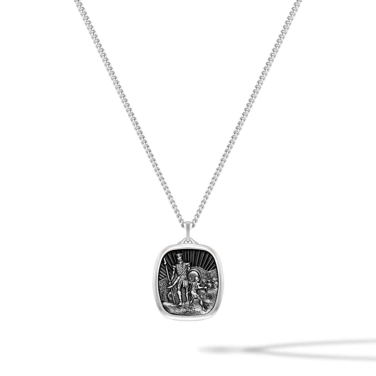 Silver necklace with a detailed pendant on a white background