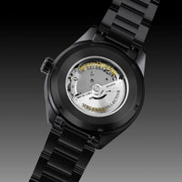 A black ceramic watch with a transparent back showing the Miyota automatic movement and gold-toned text, set against a dark gradient background.