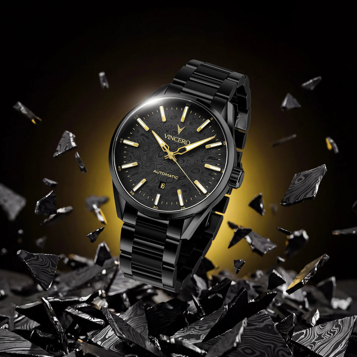 A black Seiko automatic wristwatch with a matching black metal bracelet, shown floating above shattered black glass on a dark background with a warm yellow glow behind it.