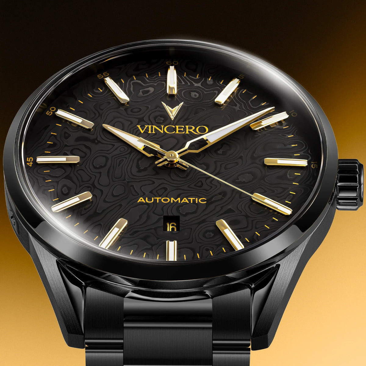 A close-up of a VINCERO automatic wristwatch with a black dial, black case, and gold-tone hands, hour markers, and brand lettering, set against a warm gradient background.