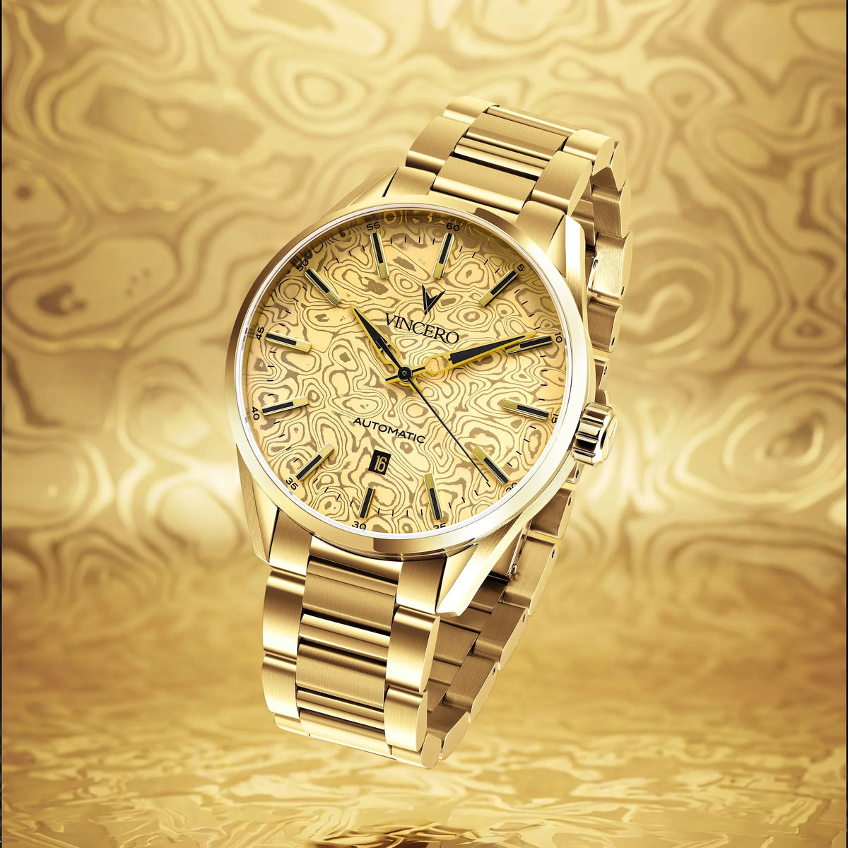 A gold-tone stainless steel wristwatch with a matching gold dial and bracelet, featuring a wavy, textured pattern on the dial and bezel, set against a matching gold background.