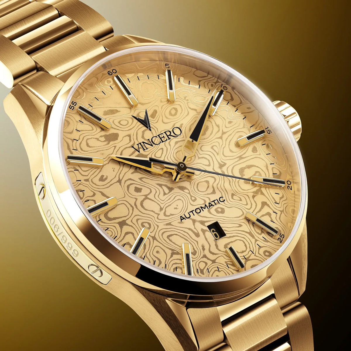 A close-up of a gold-tone wristwatch with a patterned beige dial and matching metal bracelet, shown on a warm gradient background. The dial features the brand name 'VINCERO' and 'AUTOMATIC' text.