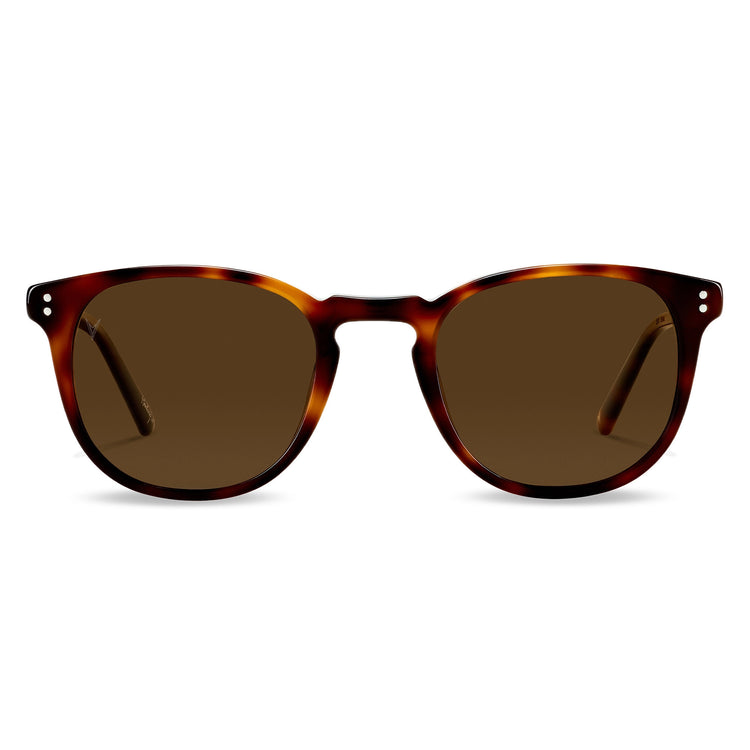 A pair of round full frame sunglasses with a patterned frame and tinted lenses.
