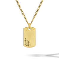 Gold necklace with a dog tag pendant on a white background