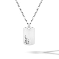 Silver dog tag necklace with engraved names on a dark textured background