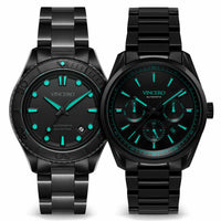 Two black Vincero watches with green faces on a white background