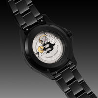 Black wristwatch with green accents on a underwater background dive watch for men