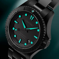 Black wristwatch with green accents on a black background