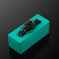 Black wristwatch with green accents on a green box dive watch for men