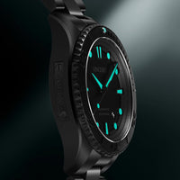 Black wristwatch with green accents on a black background