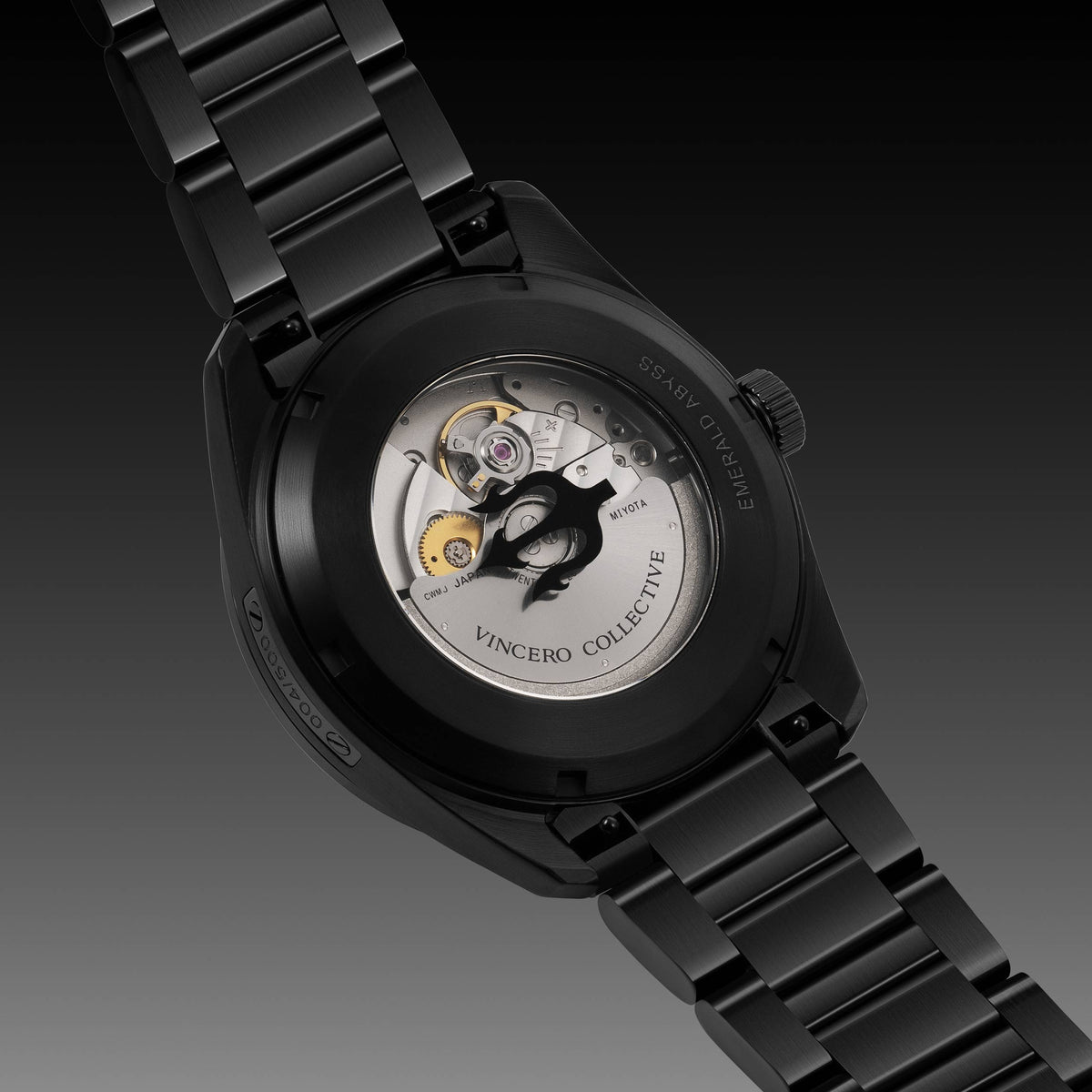 Black wristwatch with green glowing face on a BLACK background