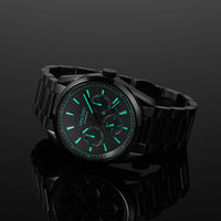Black wristwatch with green glowing face on a BLACK background for men