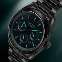 Black wristwatch with green glowing face on a BLACK background