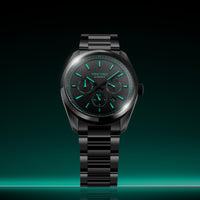 Black wristwatch with green glowing face on a BLACK background
