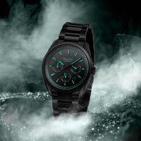 Black wristwatch with green glowing face on a BLACK background