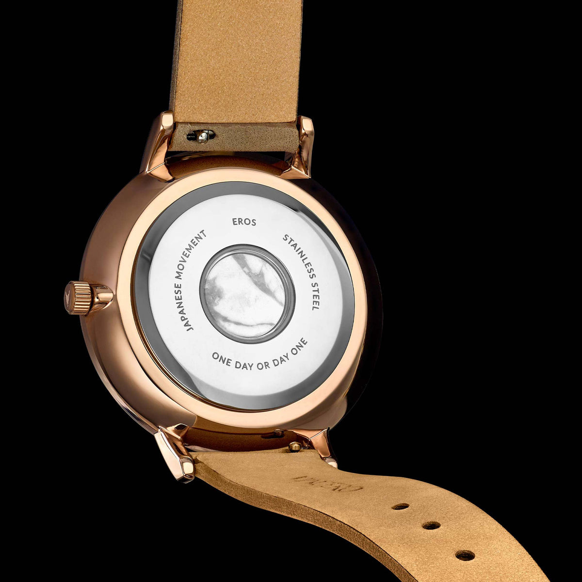 Watch with a brown leather strap and rose gold case on a black background