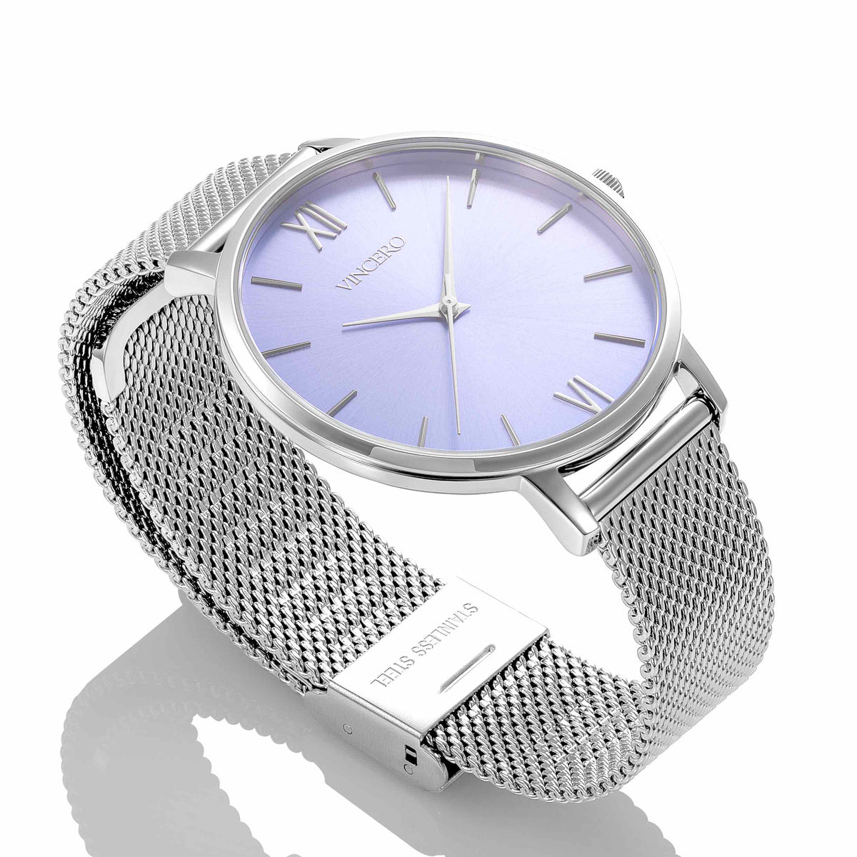 Silver watch with a mesh band and light purple dial on a white background
