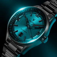 Luxury watch with blue face and black strap on a dark background