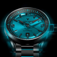 Luxury watch with blue face and black strap on a dark background