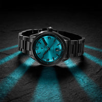 Black wristwatch with a blue glowing face on a dark textured background