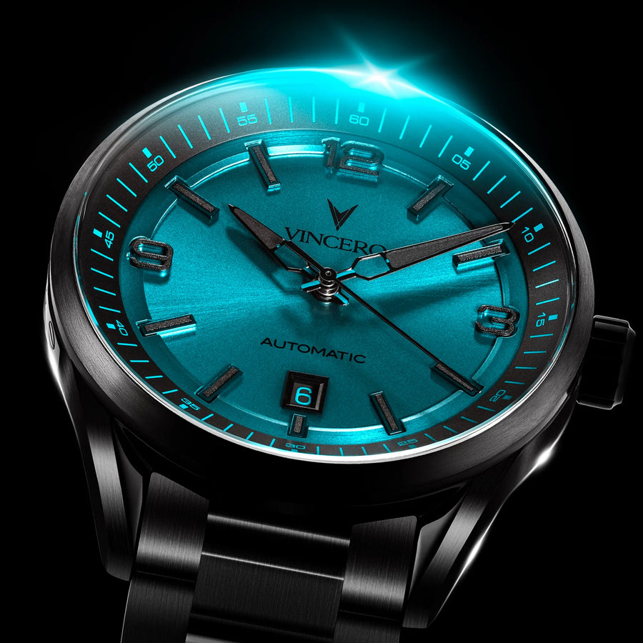 Luxury watch with blue face and black strap on a dark background