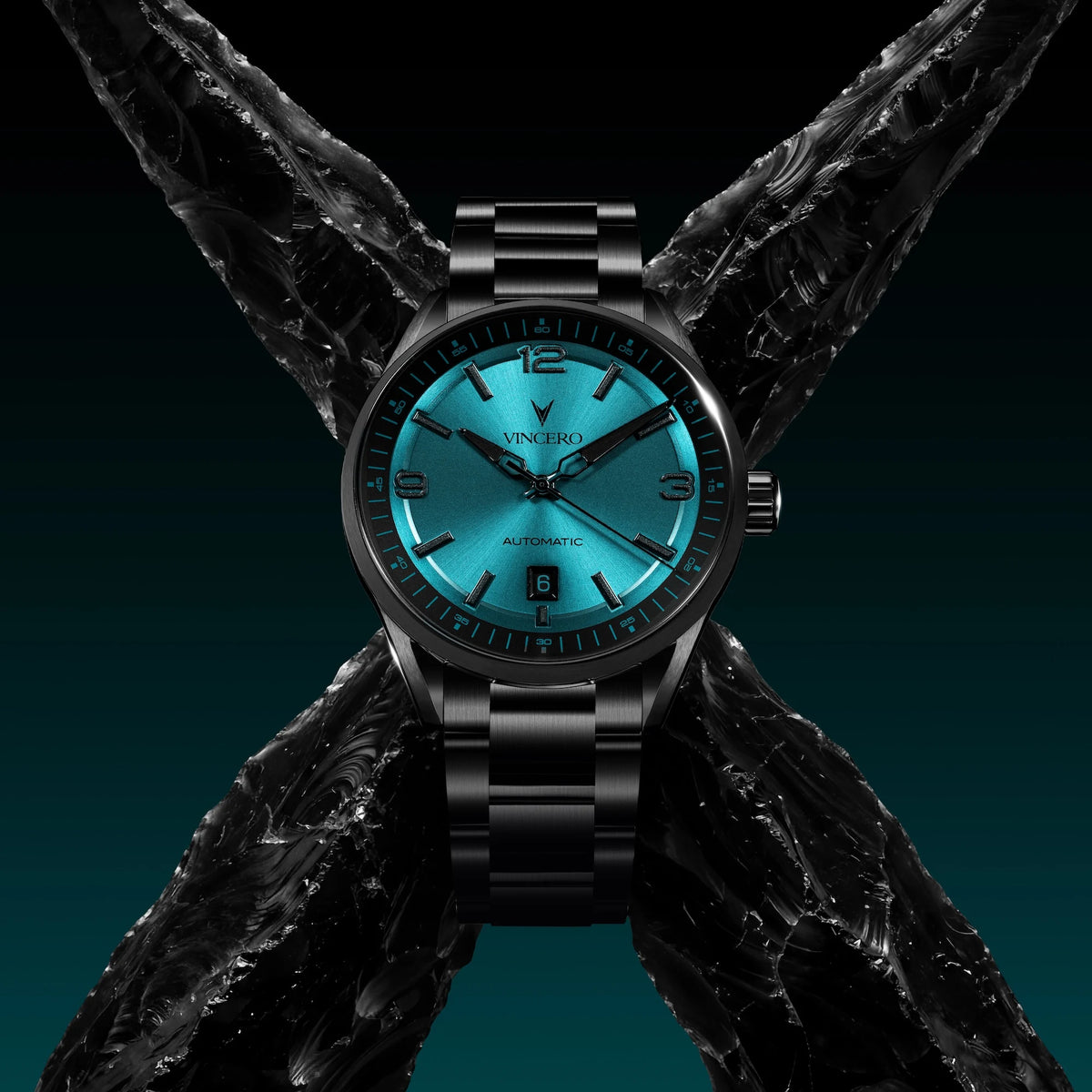 Black wristwatch with blue face on a textured black strap against a dark background