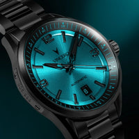 Luxury watch with blue face and black metal strap on a dark background