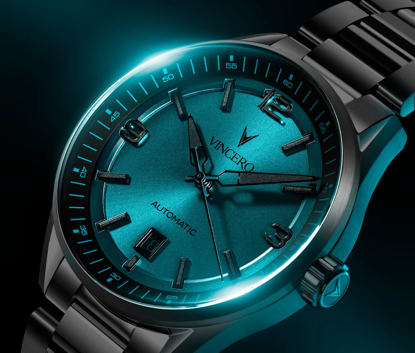 Teal wristwatch with metallic band on a dark background