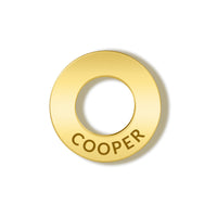 A circular gold ring-shaped accessory with the name 'COOPER' engraved along the bottom edge, shown on a clean white background with a soft drop shadow.