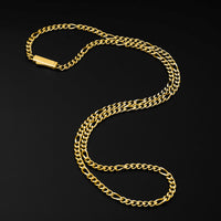 A gold-toned Cuban link chain necklace with a polished rectangular clasp, arranged in a curved S-shape on a solid black background.