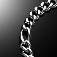 A close-up of a polished silver-tone metal curb chain curving diagonally across a dark reflective background.