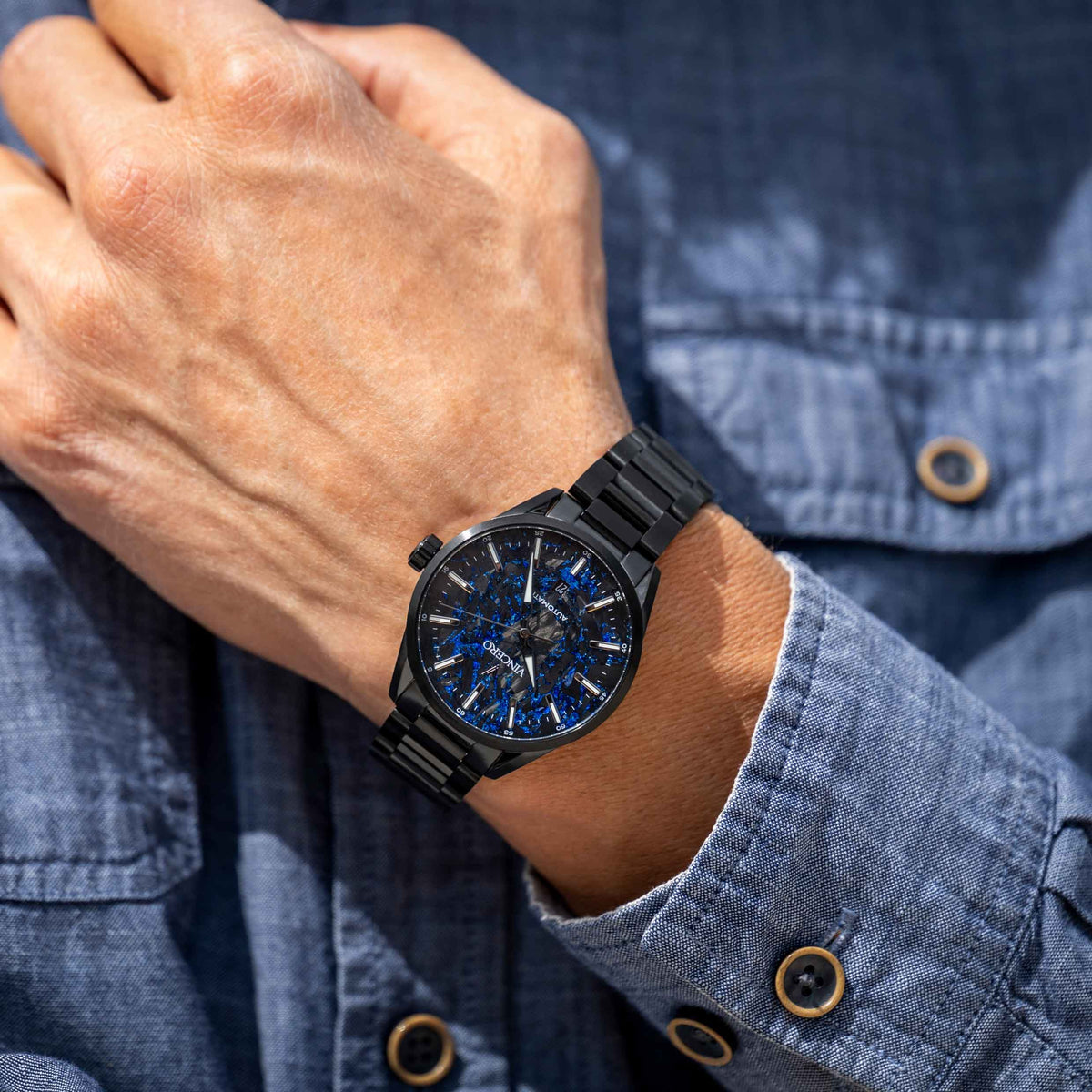 Man wearing blue Carbon men's watch. 