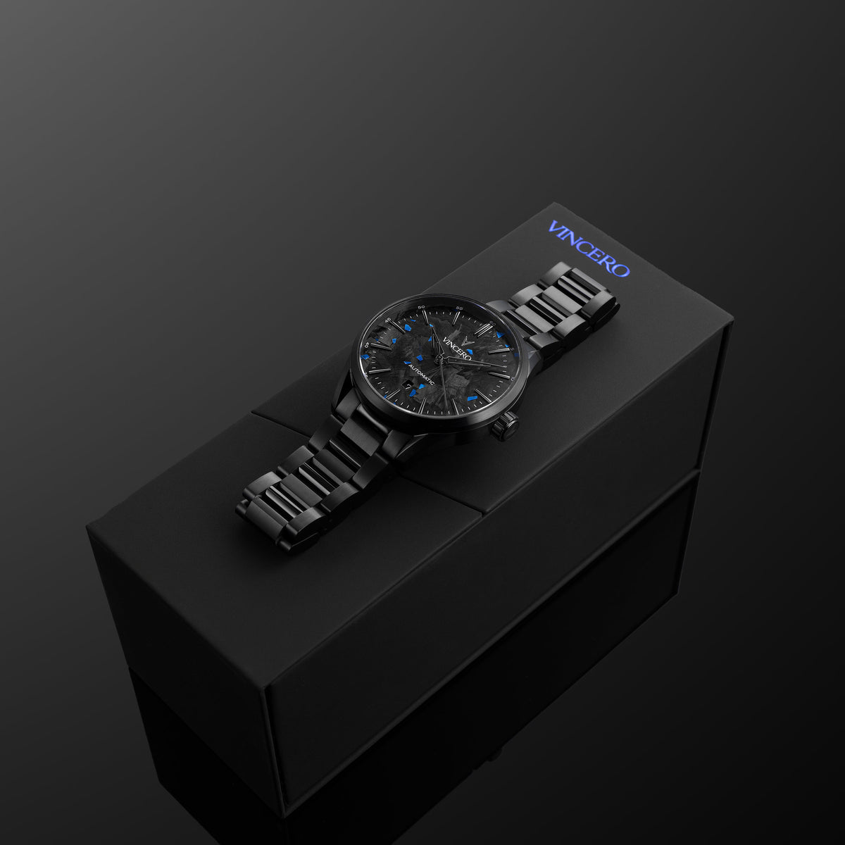 Black wristwatch on a black box with 'Vancero' branding against a dark background