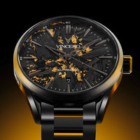 Luxury watch with black and gold design on a dark background