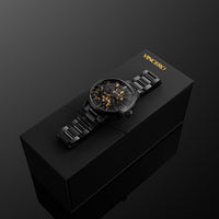 Black wristwatch on a black box with 'Vancero' branding against a dark background