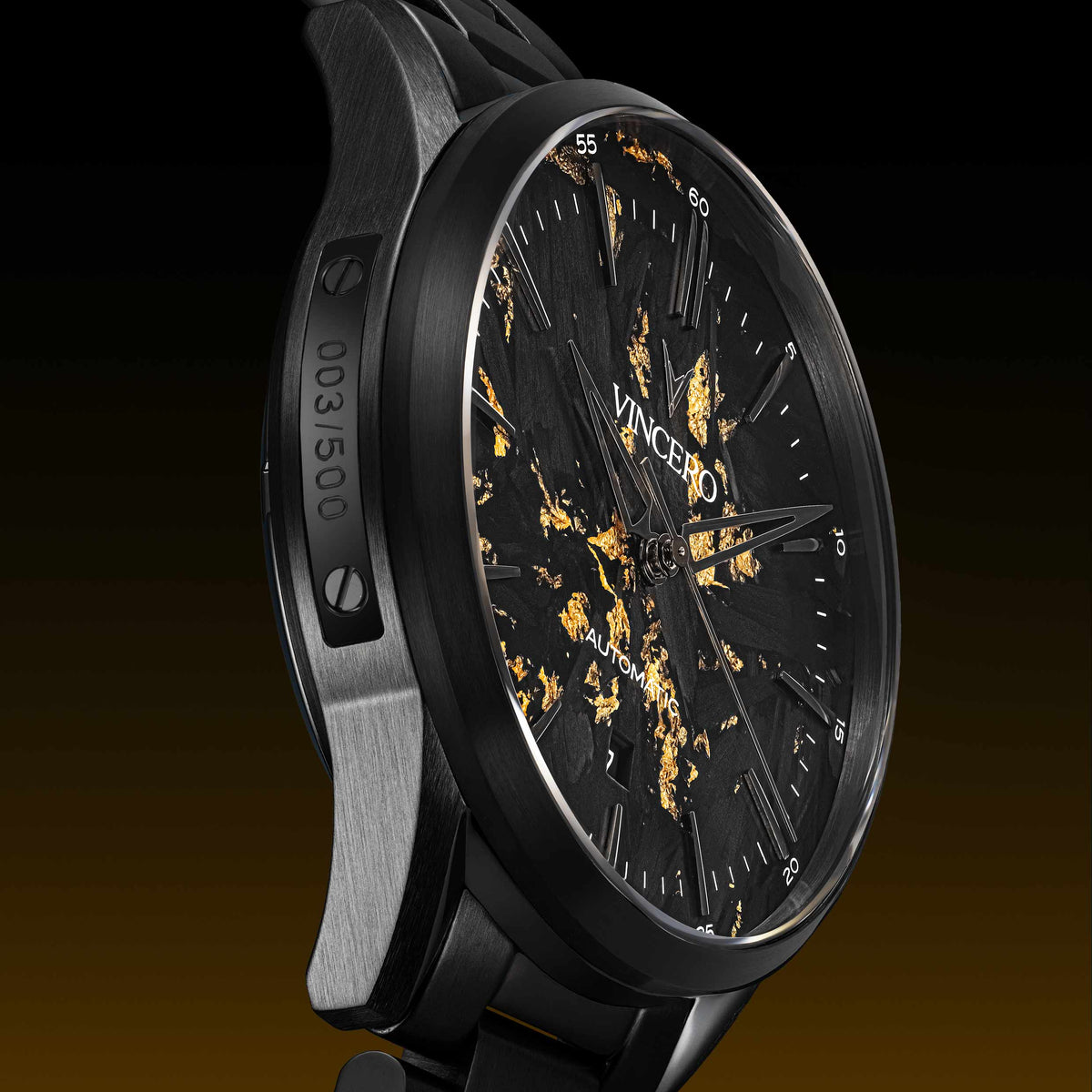 Luxury watch with black and gold design on a dark background