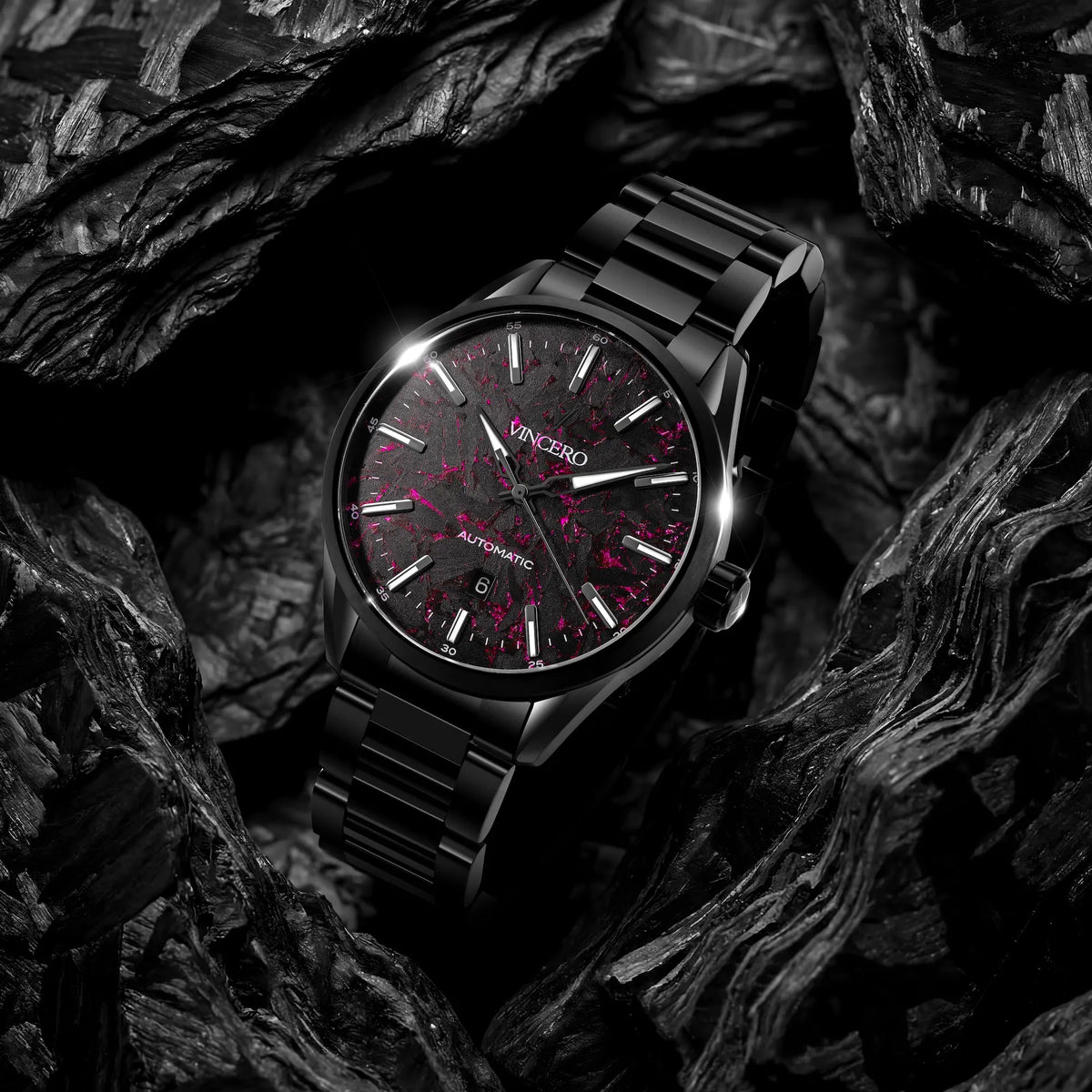 Black wristwatch with red accents on a dark textured background