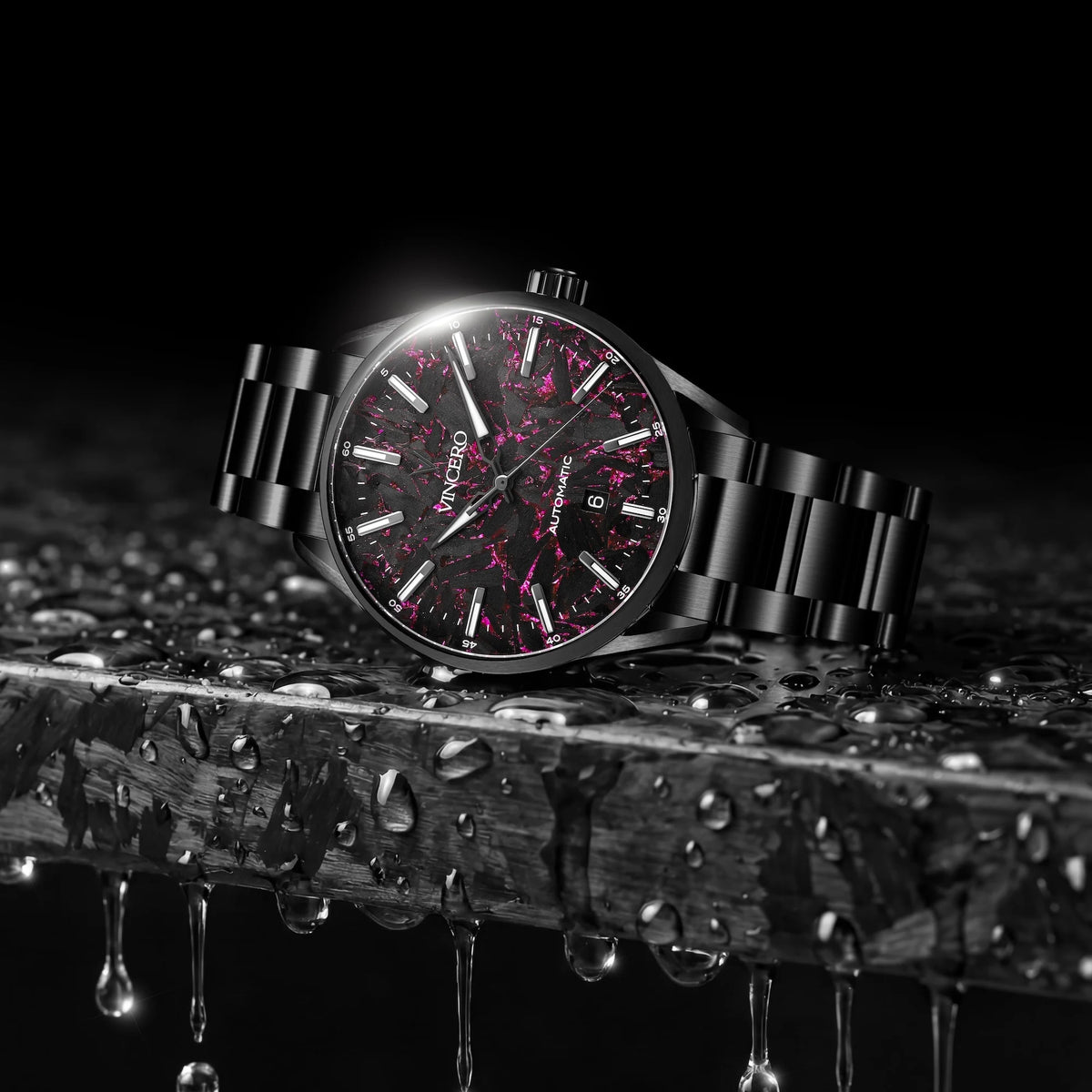 Black wristwatch with pink accents on a wet wooden surface