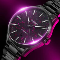 Watch with black strap and pink glowing face on a dark background
