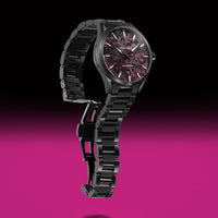 Black watch with a pink and black face on a pink background