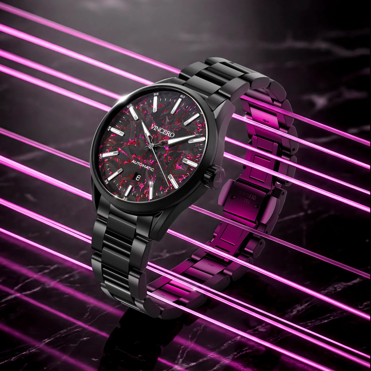 Black wristwatch with a red face on a dark background with pink neon lines
