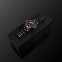 Black watch with red accents on a black box against a dark background
